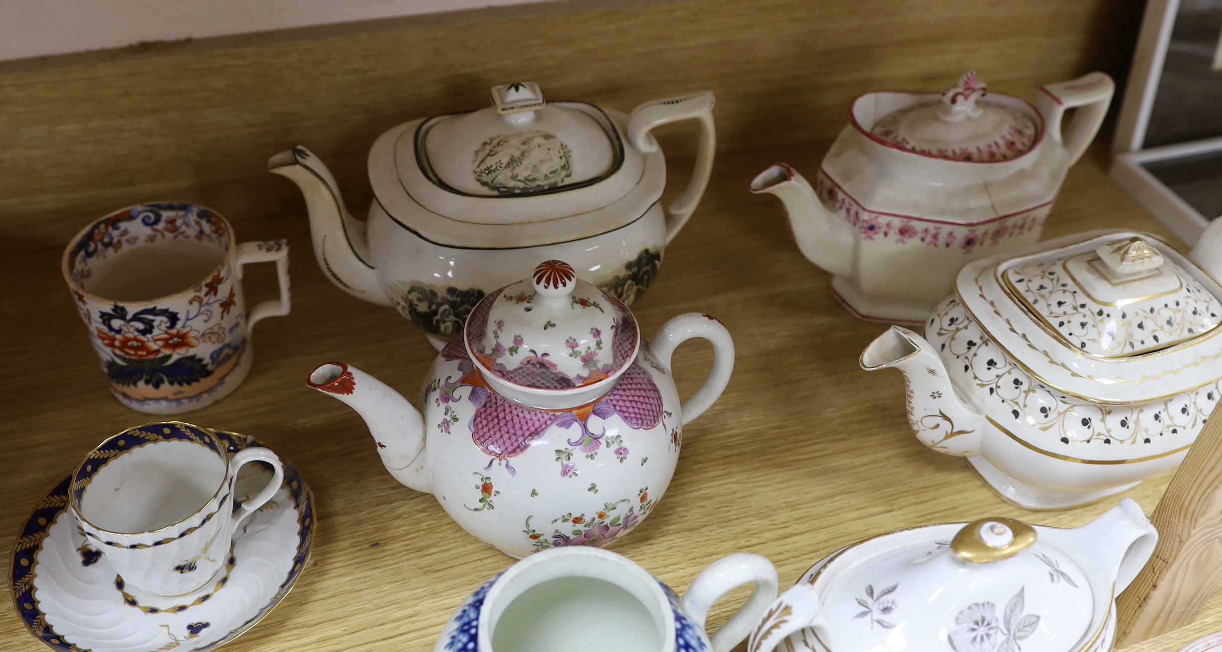 Collection of 18th century and Regency porcelain tea and coffee ware including teapots hand painted with flowers, cup and saucer with gilt decoration and a Philip Christian Liverpool sauceboat the largest 24cm wide